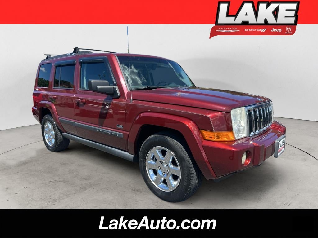 2007 Jeep Commander Sport in Red Rock Crystal Pearlcoat — front three-quarter view